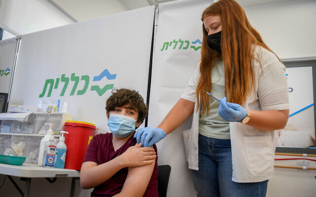 An Israeli child receives a COVID-19 vaccine at a Clalit vaccination center in Petah Tikva, on June 6, 2021. (Flash90)