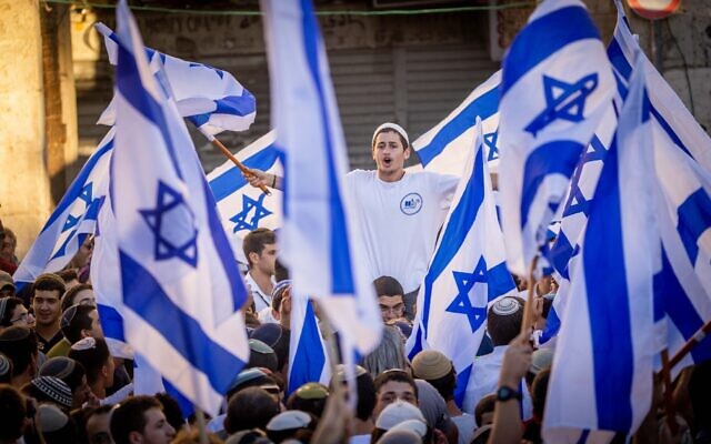 Nationalist Israeli Jews wave flags and dance at the Damascus Gate in Jerusalem's Old City, June 15, 2021. (Yonatan Sindel/Flash90)