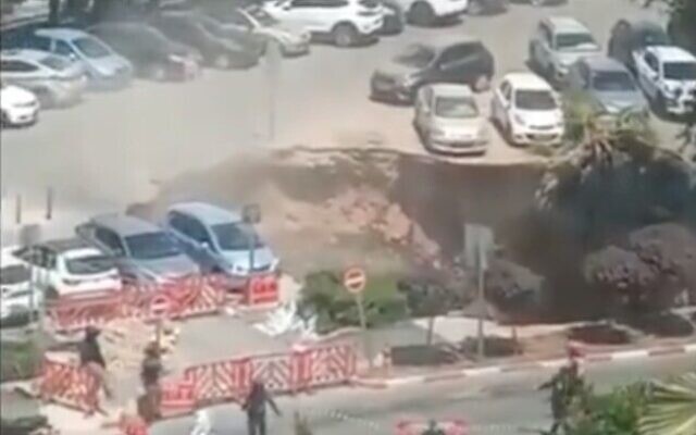 Screen capture from video of a sinkhole that opened in the parking lot of the Shaare Zedek Medical Center in Jerusalem, June 7, 2021. (Twitter)