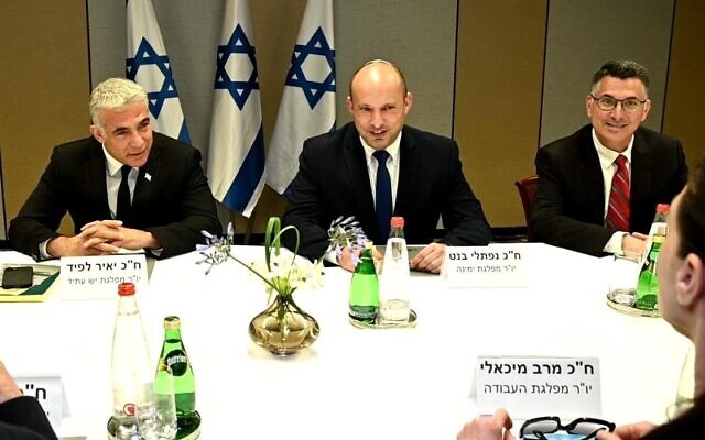 (L-R) Yesh Atid leader Yair Lapid, Yamina chair Naftali Bennett and New Hope head Gideon Sa’ar at a meeting of the heads of the would-be-coalition in Tel Aviv, June 6, 2021. (Ra’anan Cohen)