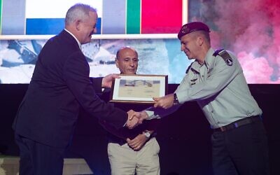Defense Minister Benny Gantz, left, and former IDF chief of staff Shaul Mofaz, center, award IDF Chief of Staff Aviv Kohavi with the first campaign medal marking Israel's 18-year occupation of southern Lebanon, at a ceremony north of Tel Aviv on June 7, 2021. (Israel Defense Forces)