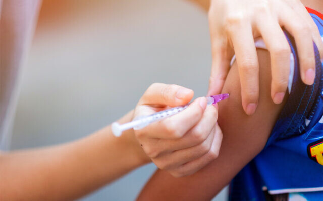 Nurses vaccinating a child (TAO EDGE via iStock by Getty Images)