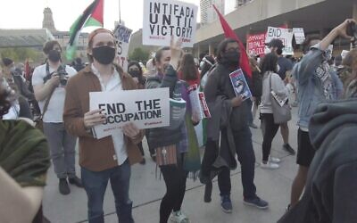 A woman holds a sign that says 'Intifada until victory' at a pro-Palestinian rally held during Israel's Operation Guardian of the Walls, in Nathan Phillips Square, downtown Toronto, May 15, 2021. (Screenshot YouTube)