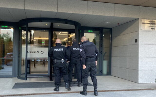 Police enter a building on May 11, 2021, in connection with an 'action day' against alleged investment fradusters. (Rheinland Pflaz Police)