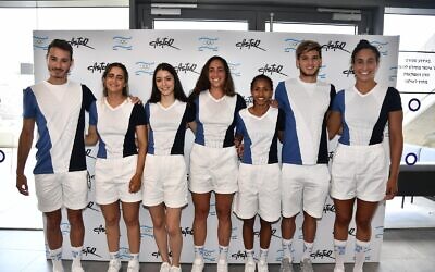 Seven Israeli athletes at the upcoming Tokyo Olympic games model the T-shirts and shorts that are part of their official uniforms. (Amit Schussel/IOC)