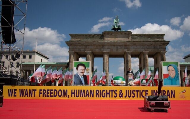 Demonstrators take part in a protest called by the National Council of Resistance of Iran (NCRI) against the Iranian regime, in front of the Brandenburg Gate in Berlin, July 10, 2021. (Paul Zinken/AFP)