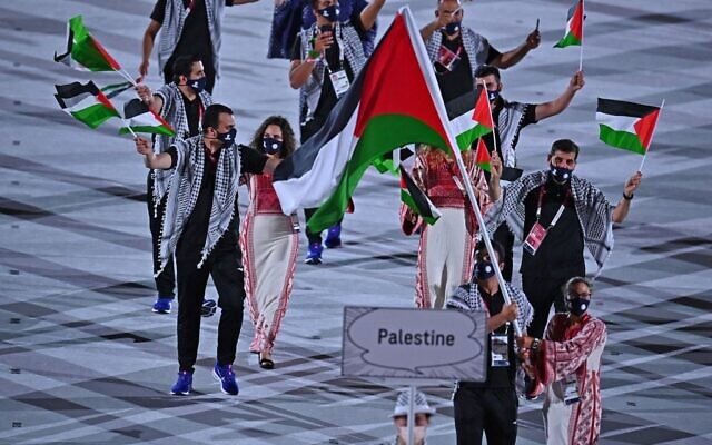 Palestine's flag bearer Dania Nour and their delegation parade during the opening ceremony of the Tokyo 2020 Olympic Games, at the Olympic Stadium, in Tokyo, on July 23, 2021. (Ben STANSALL / AFP)