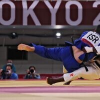 France's Teddy Riner (white) and Israel's Or Sasson compete in the judo mixed team's quarterfinal bout during the Tokyo 2020 Olympic Games at the Nippon Budokan in Tokyo on July 31, 2021. (Jack GUEZ / AFP)