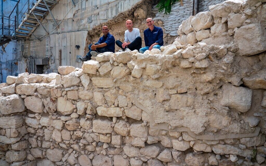 The excavation directors sitting on the exposed section of the First Temple-era protective wall on Jerusalem's eastern perimeter. (Yaniv Berman/ Israel Antiquities Authority)