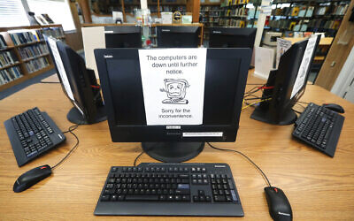 Illustrative: An Aug. 22, 2019 file photo shows signs on a bank of computers telling visitors that the machines are not working at the public library in Wilmer, Texas. (AP/Tony Gutierrez)