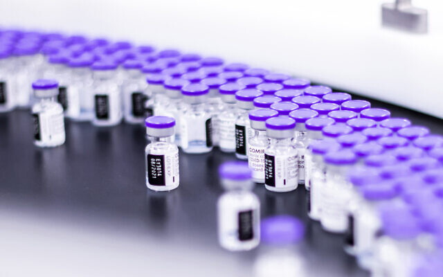Vials of the Pfizer-BioNTech COVID-19 vaccine are prepared for packaging at the company’s facility in Puurs, Belgium, March 2021. (Pfizer via AP)
