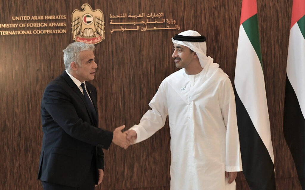 Foreign Minister Yair Lapid shakes hands with United Arab Emirates Foreign Minister Sheikh Abdullah bin Zayed al-Nahyan in Abu Dhabi, United Arab Emirates, Tuesday, June 29, 2021. (Shlomi Amsalem/Government Press Office via AP)