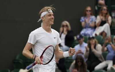 Canada's Denis Shapovalov celebrates after defeating Spain's Roberto Bautista Agut during the men's singles fourth round match on day seven of the Wimbledon Tennis Championships in London, July 5, 2021. (AP Photo/Alberto Pezzali)