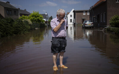 Wiel de Bie, 75, stands outside his flooded home in the town of Brommelen, Netherlands, on July 17, 2021. (AP Photo/Bram Janssen)