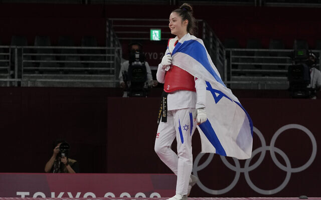 Israel's Avishag Semberg walks off the ring after defeating Turkey's Rukiye Yıldırım to win a bronze medal during the women's 49kg taekwondo match at the 2020 Summer Olympics, on Saturday, July 24, 2021, in Tokyo, Japan. (AP Photo/Themba Hadebe).