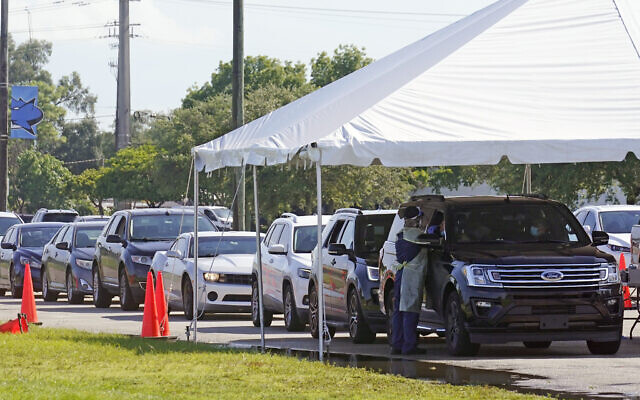 Cars line up at Miami Dade College North campus' COVID-19 testing site, July 29, 2021, in Miami (AP Photo/Marta Lavandier)
