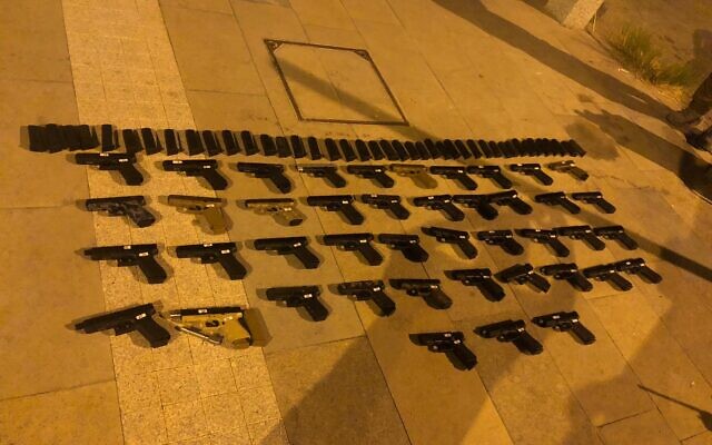 Dozens of guns seized during a smuggling operation from Lebanon, on July 10, 2021. (Israel Defense Forces)