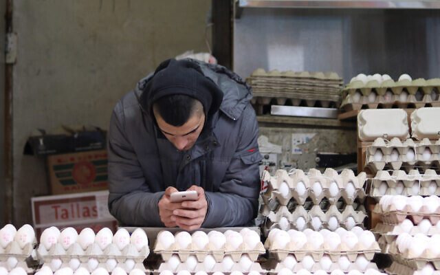 A man selling eggs at an eggstand in the Machane Yehuda Market, in Jerusalem, January 27, 2018. (Liba Farkash/ Flash 90)
