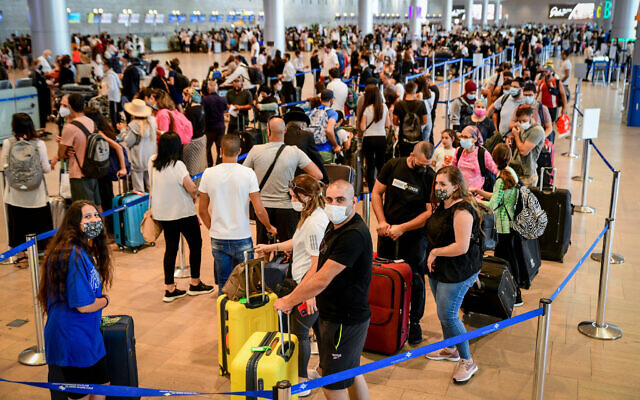 Travelers seen in the departure hall at the Ben Gurion International Airport, on July 19, 2021. (Avshalom Sassoni/Flash90)