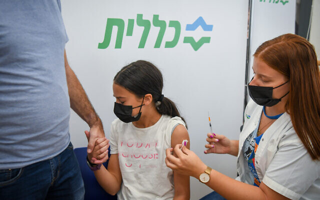 An Israeli youth receives a COVID-19 vaccine shot at a vaccination center in Petah Tikva, July 19, 2021. (Flash90)