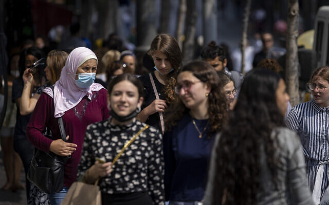 People, some wearing face masks, walk on Jaffa Street in Jerusalem, July 25, 2021. (Olivier Fitoussi/Flash90)