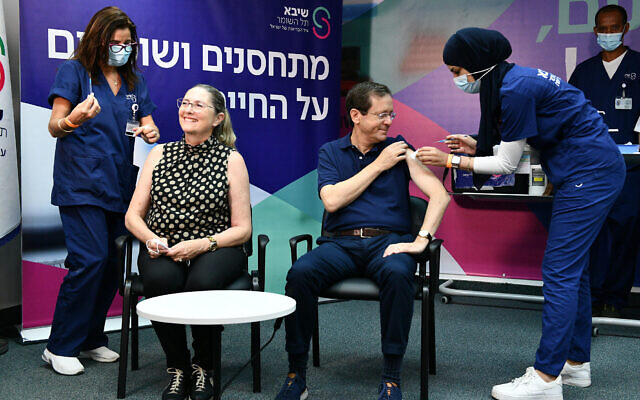 President Isaac Herzog and his wife Michal receive their third COVID-19 vaccine shots at Sheba Medical Center, July 30, 2021. (Haim Zach/GPO)