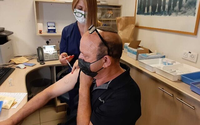 A man receives a booster dose of the coronavirus vaccine at Sheba Medical Center outside of Tel Aviv on July 12, 2021. (Courtesy Sheba Medical Center)