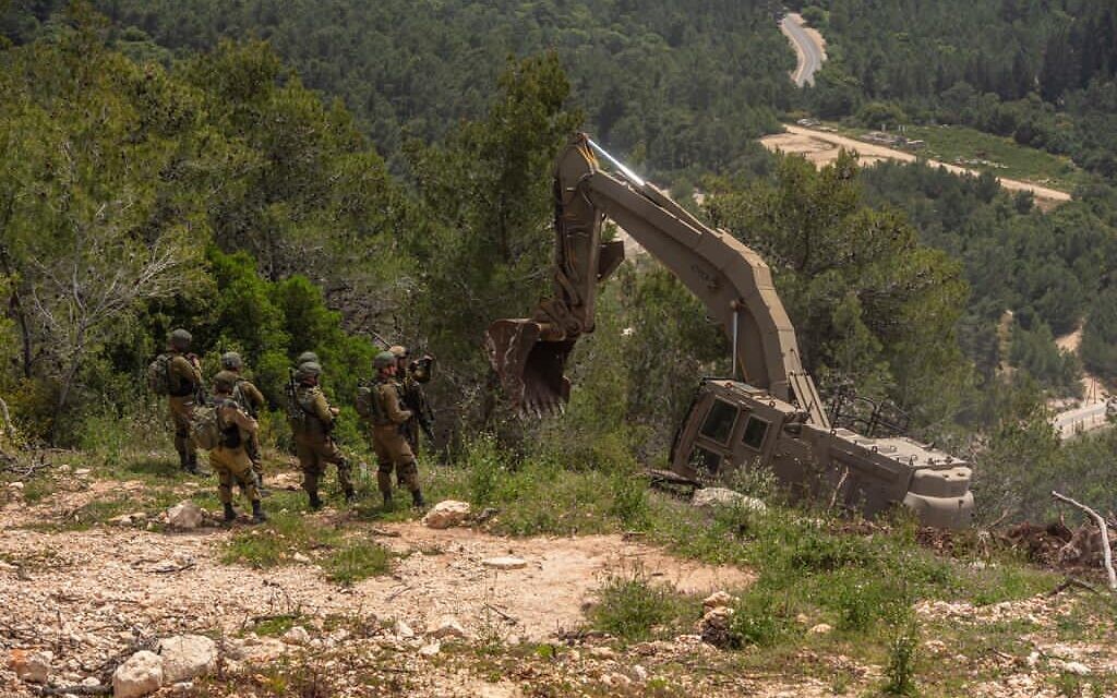 IDF engineering vehicles set up defense positions set up along the Lebanese border in an undated photograph. (Israel Defense Forces)