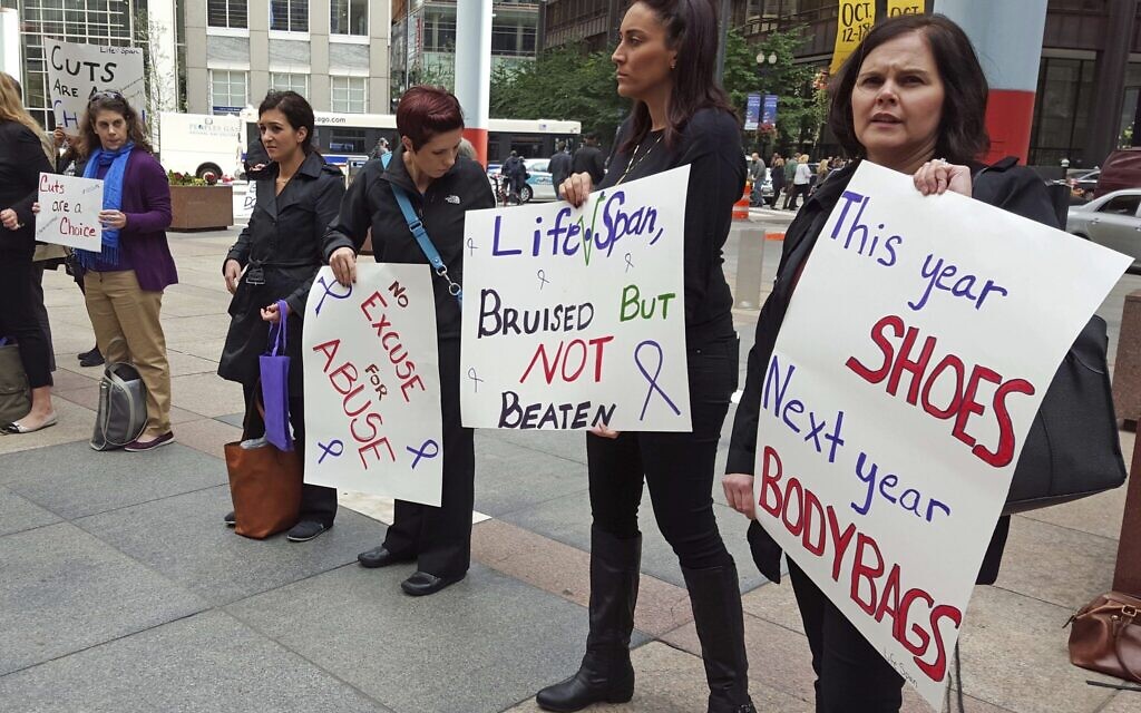 Illustrative: advocates for victims of domestic abuse protest outside of state offices in downtown Chicago,  October 1, 2015. (AP Photo/Sophia Tareen, File)