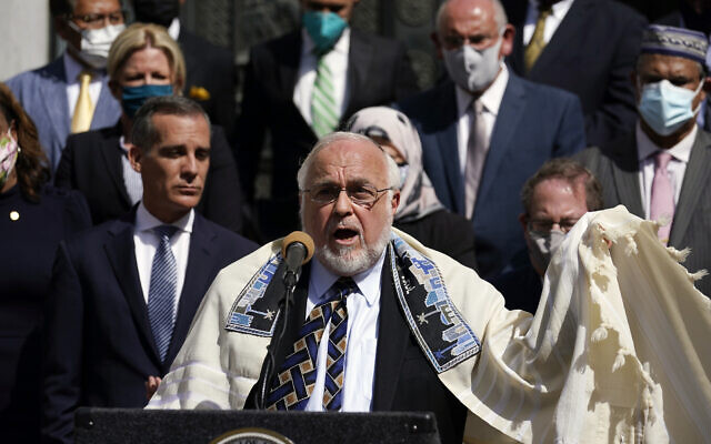 Rabbi Abraham Cooper, center, of the Simon Wiesenthal Center, speaks in front of civic and faith leaders outside City Hall, May 20, 2021, in Los Angeles. (AP Photo/Marcio Jose Sanchez)