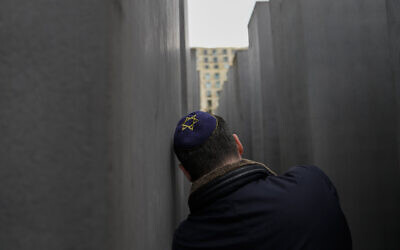 A man with a skullcap takes a photo at the Holocaust Memorial in Berlin, Germany, on Thursday, May 27, 2021. (AP Photo/Markus Schreiber)