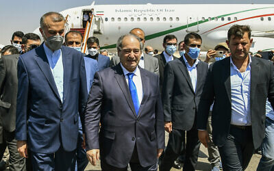 Syria's Foreign Minister Faisal Mekdad, center left, receives Iran's new Foreign Minister Hossein Amir-Abdollahian, left, in Damascus, Syria, August 29, 2021. (SANA via AP)