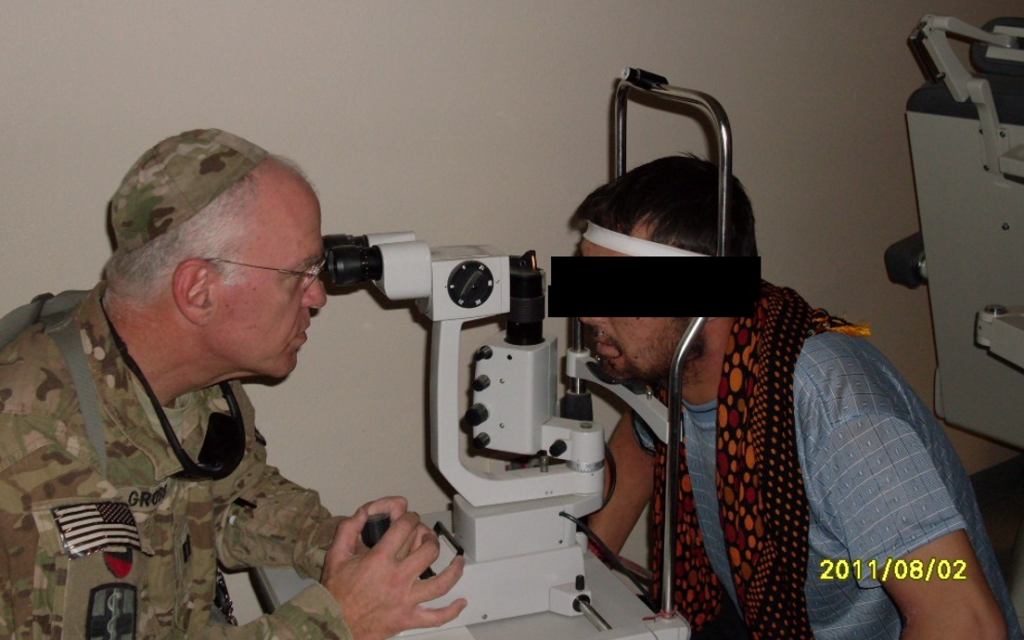 US Army Captain Warren Gross (L)  at an Afghan military hospital with an Afghan coalition force soldier who suffered an eye injury, August 2011 (courtesy)