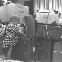 A Jewish child immigrant From Casablanca, Morrocco, is seen with luggage at Lod Airport, September 24, 1955. (ELDAN DAVID/GPO)