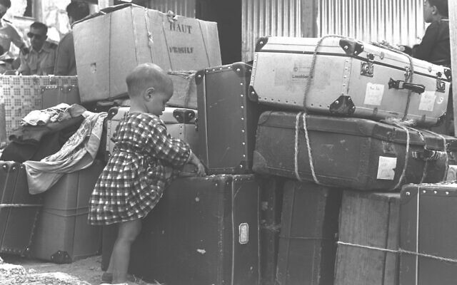 A Jewish child immigrant from Casablanca, Morocco, is seen with luggage at Lod Airport, September 24, 1955. (ELDAN DAVID/GPO)