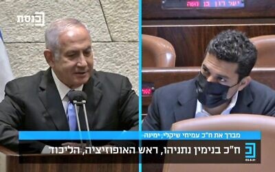 Opposition leader Benjamin Netanyahu (L) addresses Yamina MK Amichai Chikli following the rookie lawmaker's maiden Knesset speech, August 3, 2021. (Screen capture: Knesset Channel)