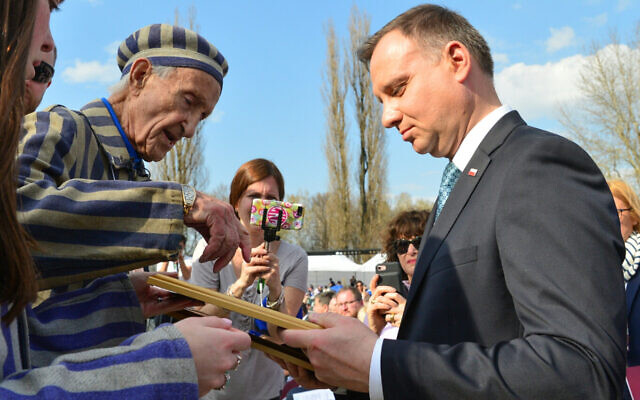 Holocaust survivor Edward Mossberg with Polish president Andrzej Duda, at a ceremony in the March of the Living at the Auschwitz-Birkenau camp site in Poland, as Israel marks annual Holocaust Memorial Day, on April 12, 2018. (Yossi Zeliger/Flash90/ File)