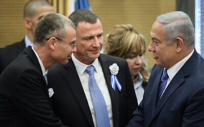 Then-prime minister Benjamin Netanyahu (right) with Yuli Edelstein (center) and Yariv Levin at the Likud party faction meeting at the Knesset on April 30, 2019 (Noam Revkin Fenton/Flash90)