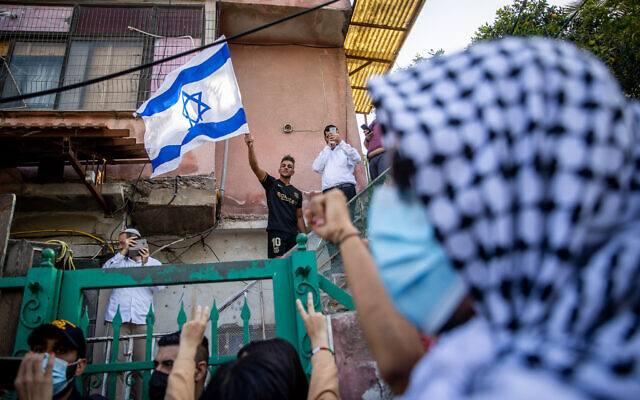 Palestinians and left wing activists protest against the expulsion of Palestinian families from homes in a property dispute in the Jerusalem neighborhood of Sheikh Jarrah. April 16, 2021. (Yonatan Sindel/Flash90)
