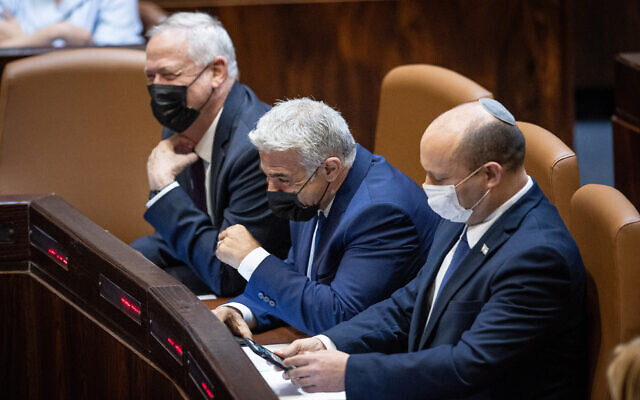 (From left to right) Defense Minister Benny Gantz, Foreign Minister Yair Lapid and Prime Minister Naftali Bennett at the Knesset in Jerusalem, on August 2, 2021. (Yonatan Sindel/Flash90)