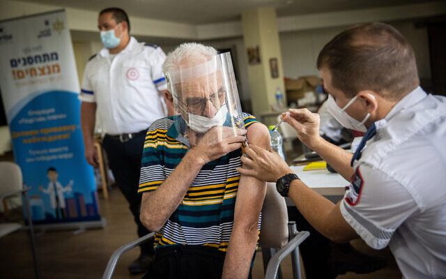 A resident from the Amigor elder care facility receives a third dose of the coronavirus vaccine on August 4, 2021. (Yonatan Sindel/Flash90)