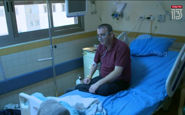 Labor MK Gilad Kariv speaks to Channel 13 news from his hospital bed in the coronavirus ward of Sheba Medical Center, on August 18, 2021. (Screenshot/Channel 13)