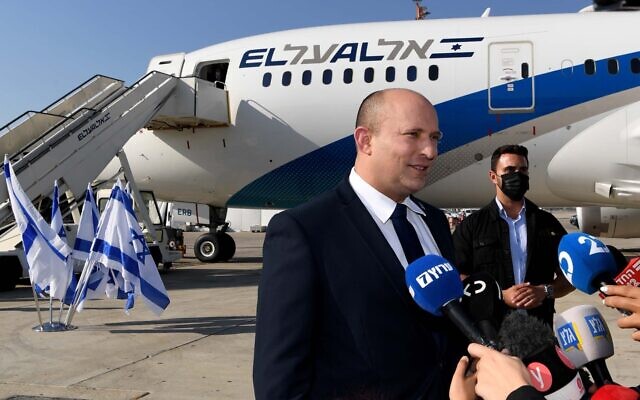 Prime Minister Naftali Bennett speaks to reporters before departing Ben Gurion Airport for Washington on August 24, 2021 (Avi Ohayon/GPO)