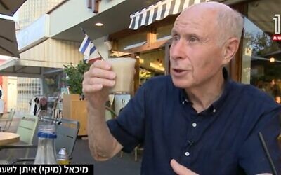 Former MK Michael Eitan holds a cup of coffee four months after brain surgery to relieve him of symptoms of Parkinson's disease.(Screncapture/Channel 12)