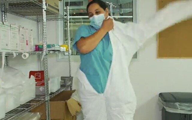Nurse Maysoon Makladeh prepares for a shift in the coroanvirus ward of Petah Tikva's Beilinson Medical Center (Screencapture/Channel 12)