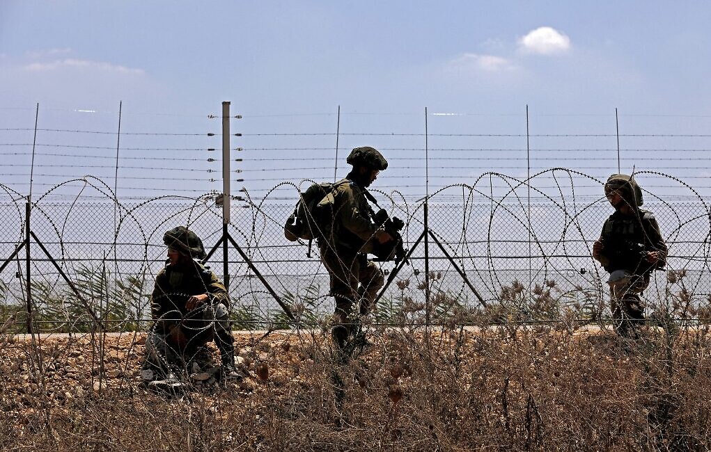 Israeli troops patrol along the security fence in the village of Muqeibila, near the northern West Bank city of Jenin, on September 6, 2021, following the escape of six Palestinian security prisoners from an Israeli prison. (Jalaa Marey/AFP)