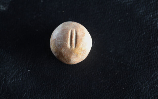 An ancient stone weight, marked as being two-gerah that was discovered near the Old City of Jerusalem. (Eliyahu Yanai, City of David)