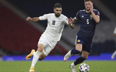 File: Israel's Moanes Dabour, left, fights for the ball with Scotland's Liam Cooper during the Euro 2020 playoff semifinal soccer match between Scotland and Israel, at the Hampden stadium in Glasgow, Scotland, Thursday, Oct. 8, 2020. (AP Photo/Scott Heppell)
