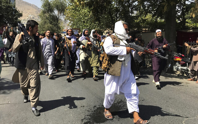 Taliban soldiers walk towards Afghans shouting slogans, during an anti-Pakistan demonstration, near the Pakistan embassy in Kabul, Afghanistan, Tuesday, Sept. 7, 2021. (AP Photo/Wali Sabawoon)