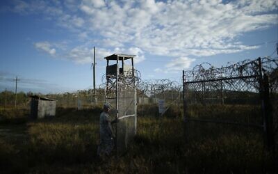 In this November 21, 2013 file photo, a soldier closes the gate at the now-abandoned Camp X-Ray, which was used as the first detention facility for al-Qaeda and Taliban militants who were captured after the September 11 attacks at Guantanamo Bay Naval Base, Cuba. (AP Photo/Charles Dharapak, File)